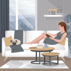 Woman reading on the couch with a pug