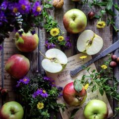 Apples and flowers beautiful set on a table